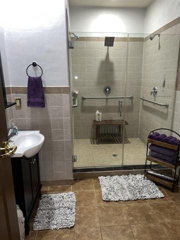 5918 Park Ridge Rd, Loves Park, IL 61111 - full bathroom with vanity, a stall shower, tile walls, and tile patterned floors