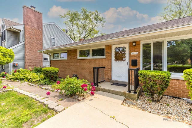 1011 Pendleton Pl, Mount Prospect, IL 60056 - property entrance with brick siding and a chimney