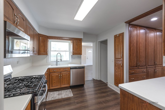 1011 Pendleton Pl, Mount Prospect, IL 60056 - kitchen with stainless steel appliances, dark wood finished floors, light countertops, recessed lighting, and brown cabinets