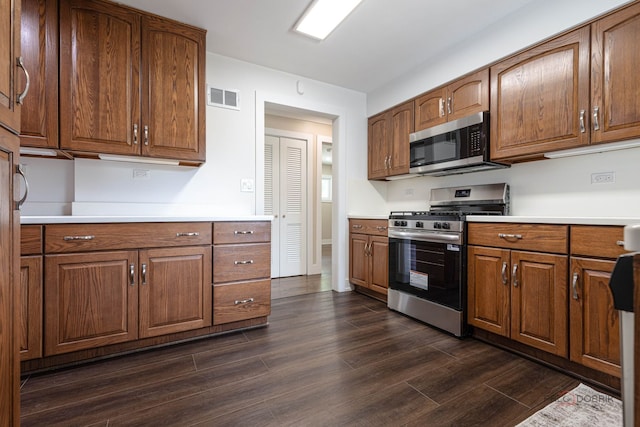 1011 Pendleton Pl, Mount Prospect, IL 60056 - kitchen with stainless steel appliances, dark wood-style flooring, brown cabinets, and light countertops