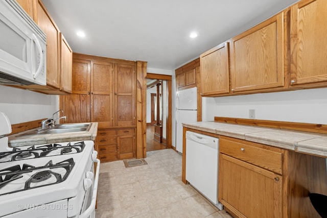 2S234 Harter Rd, Elburn, IL 60119 - kitchen featuring white appliances, tile counters, and recessed lighting