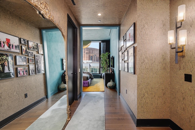 1550 N Clark St Unit 302, Chicago, IL 60610 - hallway featuring wood finished floors, arched walkways, and a textured wall