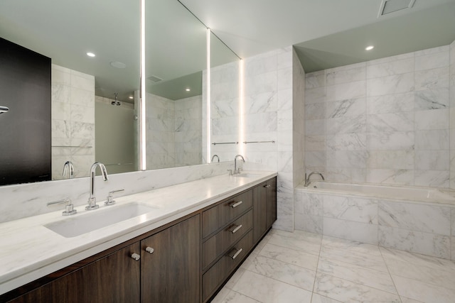 1550 N Clark St Unit 302, Chicago, IL 60610 - bathroom featuring marble finish flooring, a garden tub, double vanity, and tile walls