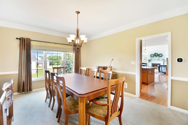 40 Open Pkwy N, Hawthorn Woods, IL 60047 - dining room with light colored carpet, a chandelier, ornamental molding, and a lit fireplace