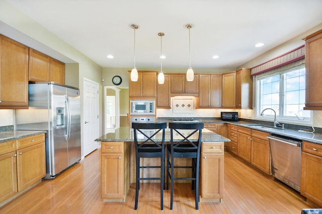 40 Open Pkwy N, Hawthorn Woods, IL 60047 - kitchen featuring appliances with stainless steel finishes, a kitchen island, light wood-type flooring, a breakfast bar area, and recessed lighting