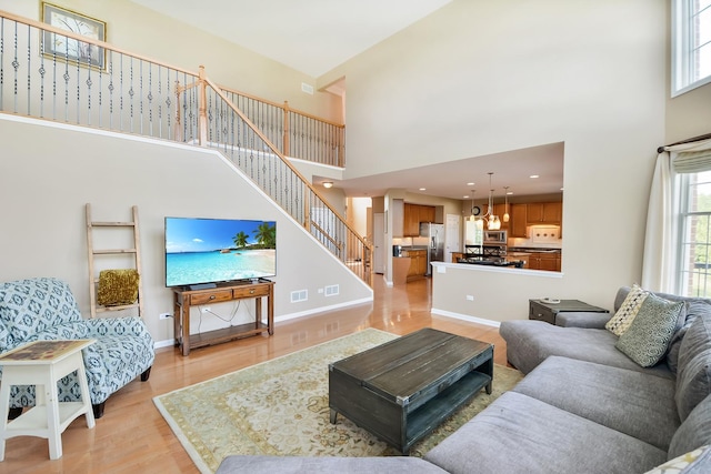 40 Open Pkwy N, Hawthorn Woods, IL 60047 - living room featuring a high ceiling, light wood-style flooring, stairs, a chandelier, and recessed lighting