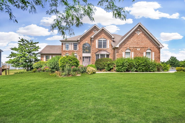 40 Open Pkwy N, Hawthorn Woods, IL 60047 - georgian-style home with brick siding, a front yard, and roof with shingles