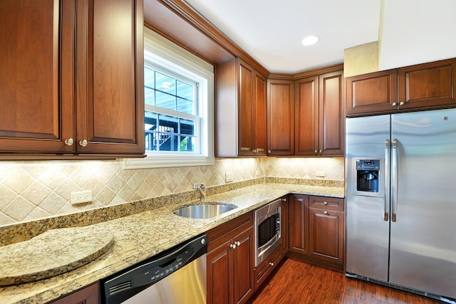 40 Open Pkwy N, Hawthorn Woods, IL 60047 - kitchen featuring appliances with stainless steel finishes, light stone countertops, dark wood-style flooring, and decorative backsplash