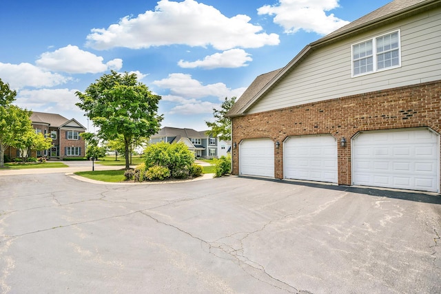 40 Open Pkwy N, Hawthorn Woods, IL 60047 - view of side of property featuring brick siding, asphalt driveway, and a residential view