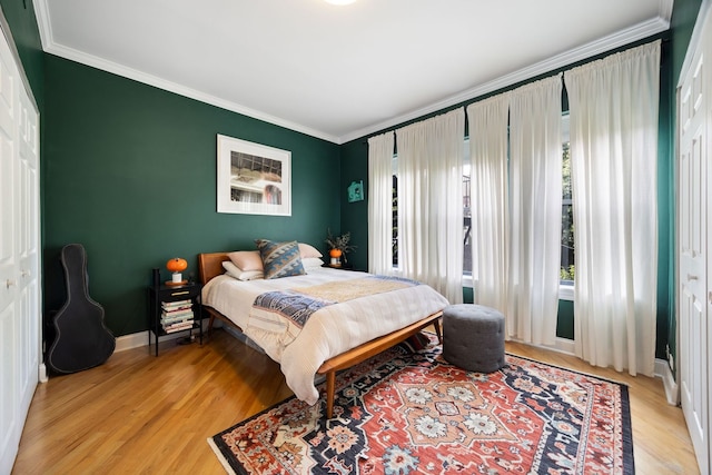 2950 W Cortland St Unit 2, Chicago, IL 60647 - bedroom with crown molding and light wood-style flooring