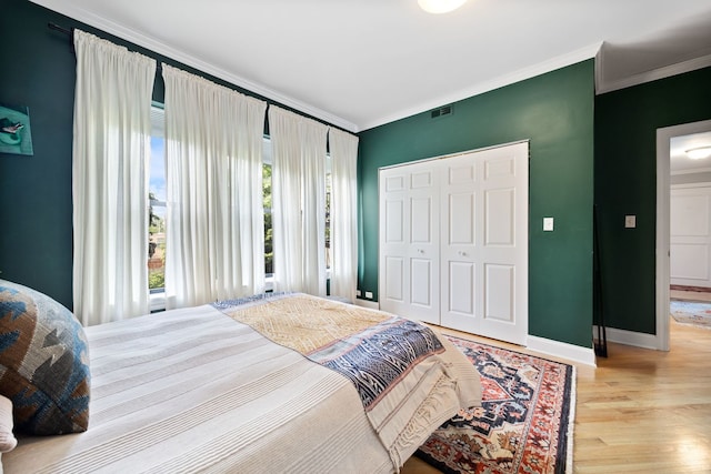 2950 W Cortland St Unit 2, Chicago, IL 60647 - bedroom with crown molding, a closet, and wood finished floors