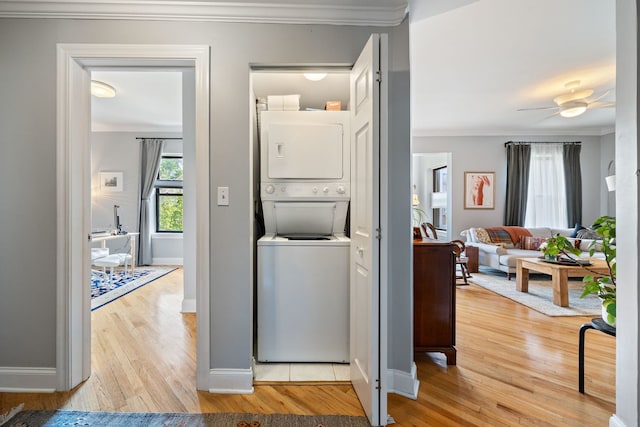 2950 W Cortland St Unit 2, Chicago, IL 60647 - washroom featuring estacked washer and dryer, crown molding, wood finished floors, and ceiling fan