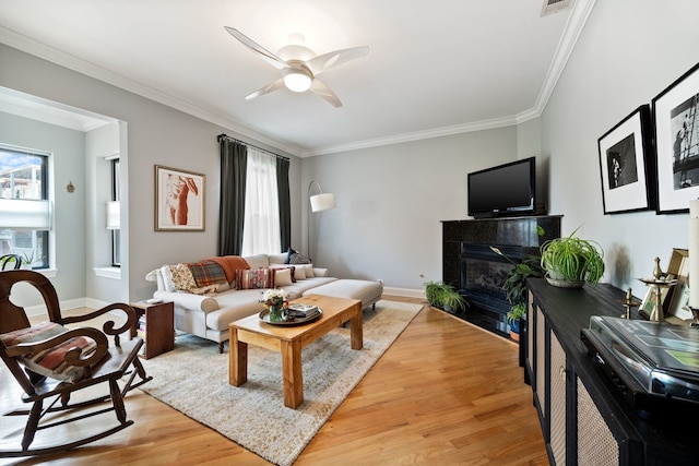 2950 W Cortland St Unit 2, Chicago, IL 60647 - living room featuring ornamental molding, light wood-type flooring, a fireplace, and a ceiling fan