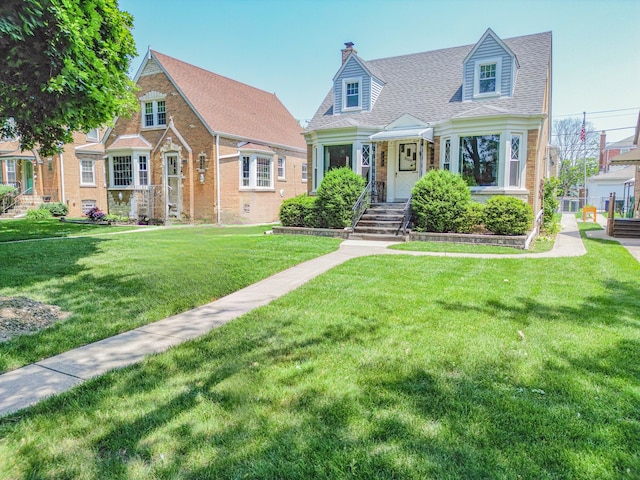 3009 N 78th Ct, Elmwood Park, IL 60707 - view of front facade featuring a chimney, a front yard, and a shingled roof