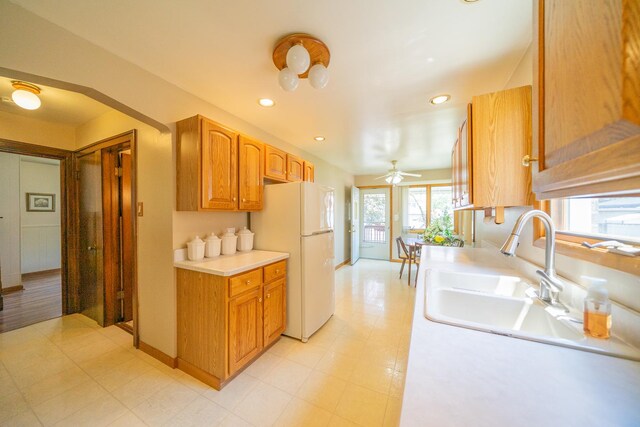 3009 N 78th Ct, Elmwood Park, IL 60707 - kitchen featuring freestanding refrigerator, light countertops, a ceiling fan, recessed lighting, and brown cabinets