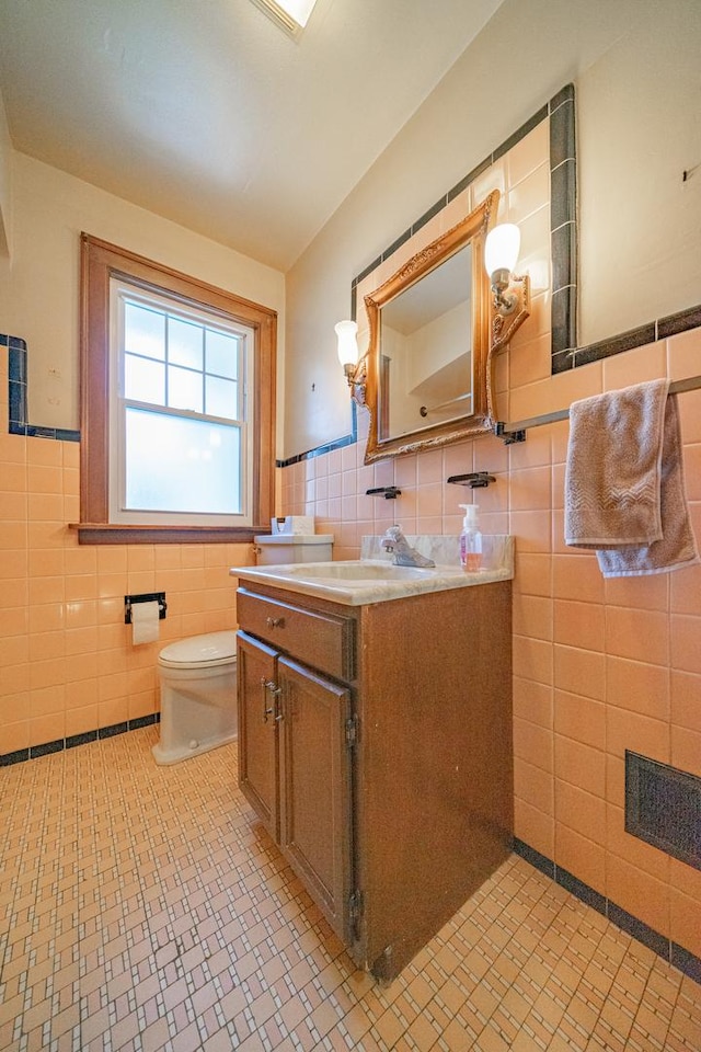 3009 N 78th Ct, Elmwood Park, IL 60707 - bathroom with tile walls, vanity, and a wainscoted wall