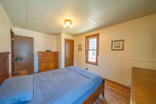 3009 N 78th Ct, Elmwood Park, IL 60707 - bedroom featuring wood finished floors, a closet, a paneled ceiling, a decorative wall, and wainscoting
