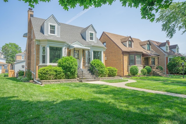 3009 N 78th Ct, Elmwood Park, IL 60707 - cape cod house with a chimney, a front lawn, brick siding, and roof with shingles
