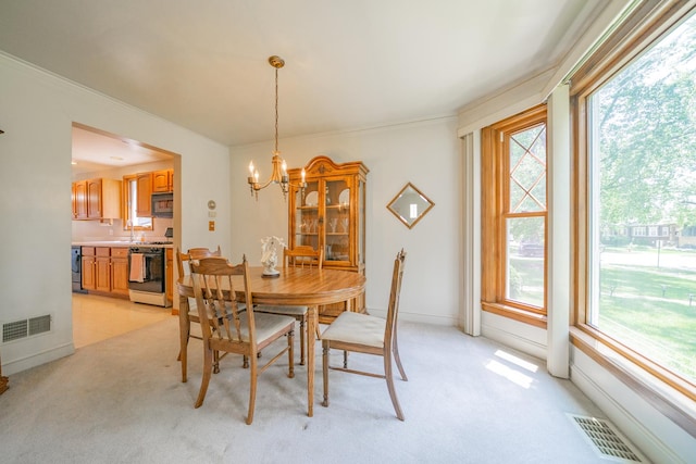 3009 N 78th Ct, Elmwood Park, IL 60707 - dining room with a chandelier, light carpet, and ornamental molding