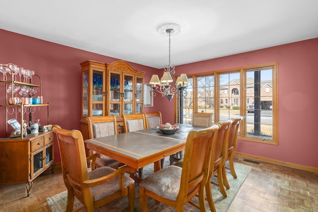 731 Queens Gate Cir, Sugar Grove, IL 60554 - dining room featuring a chandelier and baseboards