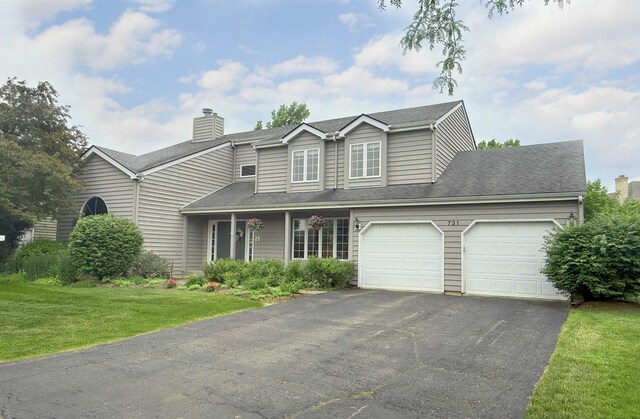 731 Queens Gate Cir, Sugar Grove, IL 60554 - traditional-style house with an attached garage, asphalt driveway, a front yard, and a chimney