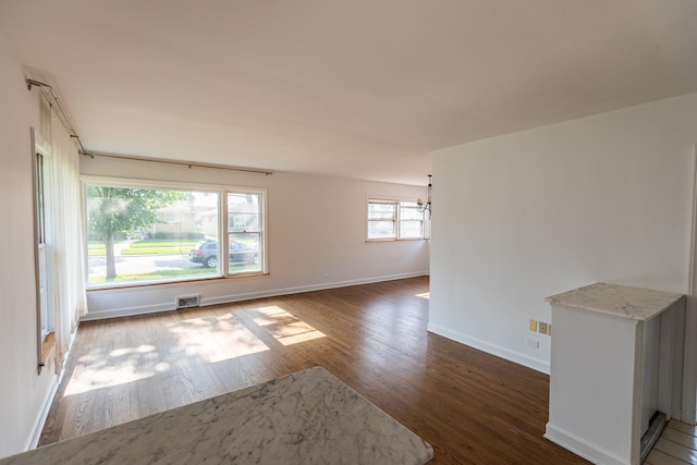 7356 N Nora Ave, Niles, IL 60714 - spare room featuring wood finished floors and a chandelier