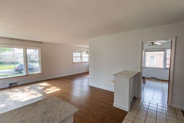 7356 N Nora Ave, Niles, IL 60714 - empty room with light wood finished floors and ceiling fan