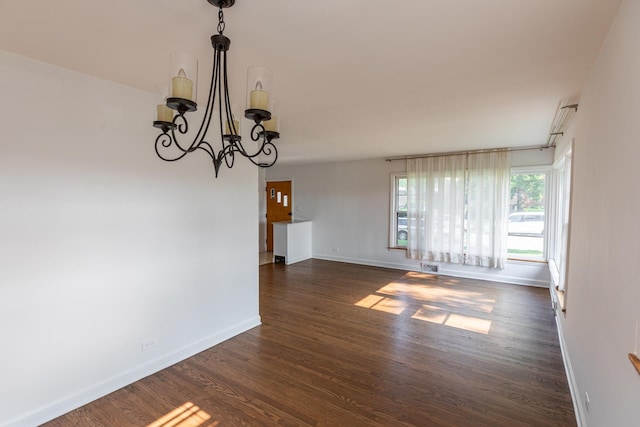 7356 N Nora Ave, Niles, IL 60714 - empty room with dark wood-style flooring and a chandelier