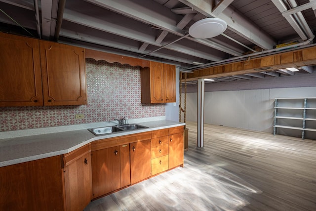 7356 N Nora Ave, Niles, IL 60714 - kitchen with wallpapered walls, light wood-type flooring, light countertops, and brown cabinets