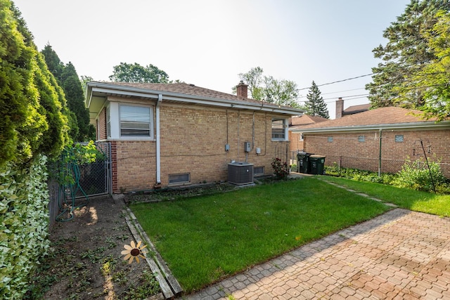 7356 N Nora Ave, Niles, IL 60714 - back of house with brick siding, a chimney, and a gate