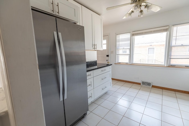 7356 N Nora Ave, Niles, IL 60714 - kitchen featuring freestanding refrigerator, dark countertops, ceiling fan, white cabinets, and light tile patterned floors