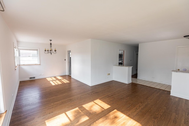 7356 N Nora Ave, Niles, IL 60714 - unfurnished living room featuring a chandelier and wood finished floors