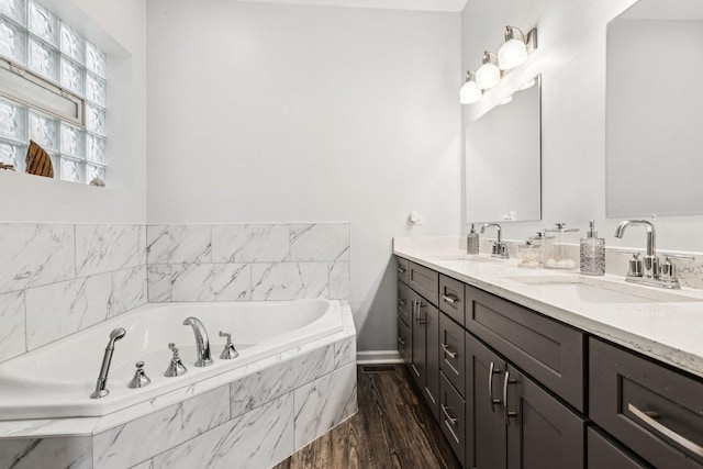 3041 N California Ave Unit 1, Chicago, IL 60618 - bathroom with double vanity, a garden tub, and wood finished floors
