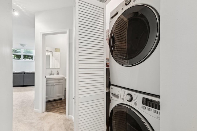 3041 N California Ave Unit 1, Chicago, IL 60618 - laundry room with stacked washer / drying machine and carpet floors
