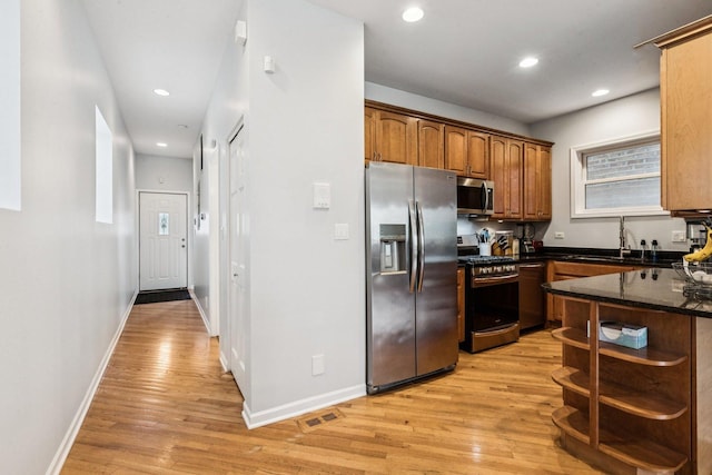 3041 N California Ave Unit 1, Chicago, IL 60618 - kitchen with appliances with stainless steel finishes, light wood-style flooring, open shelves, dark stone countertops, and recessed lighting
