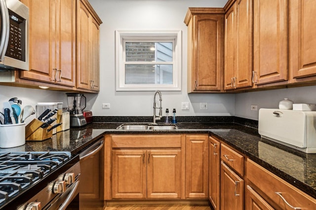 3041 N California Ave Unit 1, Chicago, IL 60618 - kitchen with appliances with stainless steel finishes, dark stone countertops, and brown cabinets