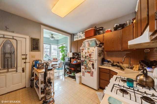 1328 W Nelson St, Chicago, IL 60657 - kitchen with white appliances, brown cabinets, light countertops, decorative backsplash, and light flooring
