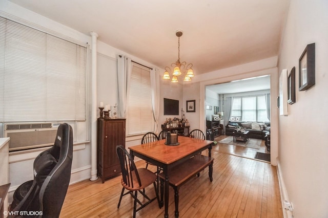 1328 W Nelson St, Chicago, IL 60657 - dining room featuring a chandelier, light wood finished floors, and cooling unit
