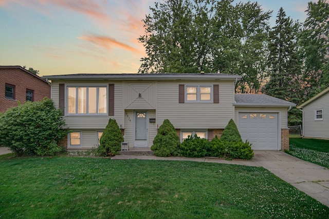 5826 Edward Dr, Oak Forest, IL 60452 - split foyer home with driveway, a garage, a yard, and brick siding