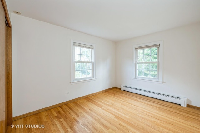 214 S Belmont Ave, Arlington Heights, IL 60005 - spare room with a baseboard heating unit, healthy amount of natural light, and wood finished floors