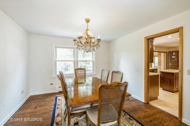 214 S Belmont Ave, Arlington Heights, IL 60005 - dining space featuring a chandelier, a baseboard heating unit, and light wood-style floors