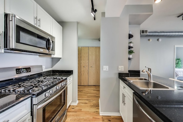 1430 S Michigan Ave Unit 510, Chicago, IL 60605 - kitchen with stainless steel appliances, light wood finished floors, white cabinets, dark stone countertops, and rail lighting
