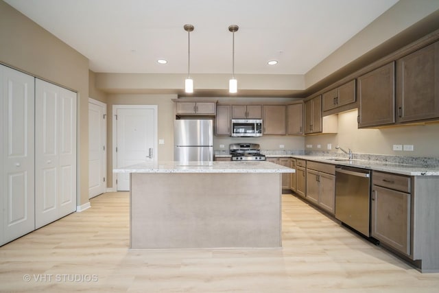 2150 Founders Dr Unit P109, Northbrook, IL 60062 - kitchen featuring stainless steel appliances, light wood-style flooring, a center island, recessed lighting, and pendant lighting