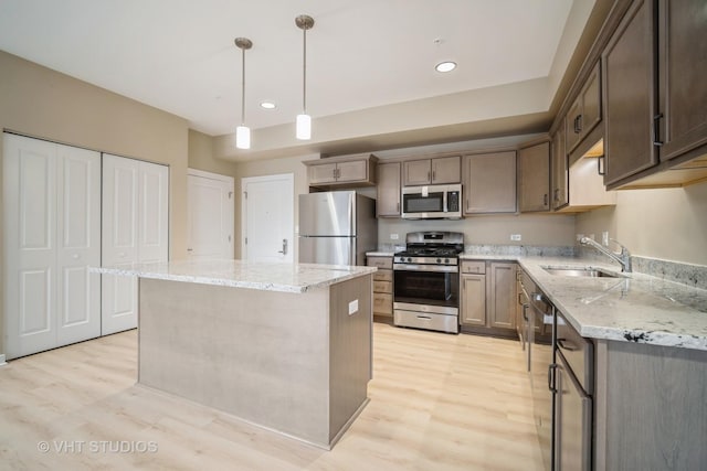 2150 Founders Dr Unit P109, Northbrook, IL 60062 - kitchen with stainless steel appliances, light wood-style flooring, a kitchen island, light stone countertops, and recessed lighting