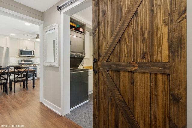 521 Everette Ave, Romeoville, IL 60446 - corridor with a barn door, dark wood-style flooring, and recessed lighting