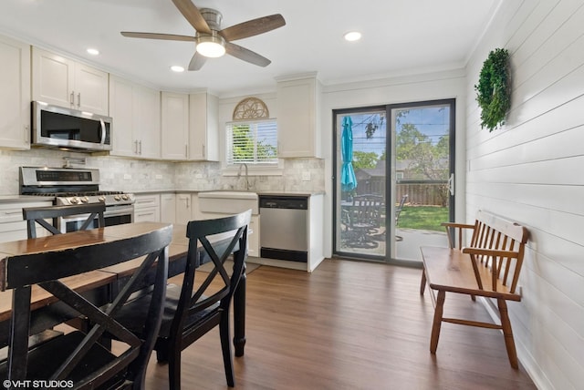 521 Everette Ave, Romeoville, IL 60446 - kitchen with appliances with stainless steel finishes, backsplash, light countertops, wood finished floors, and ornamental molding