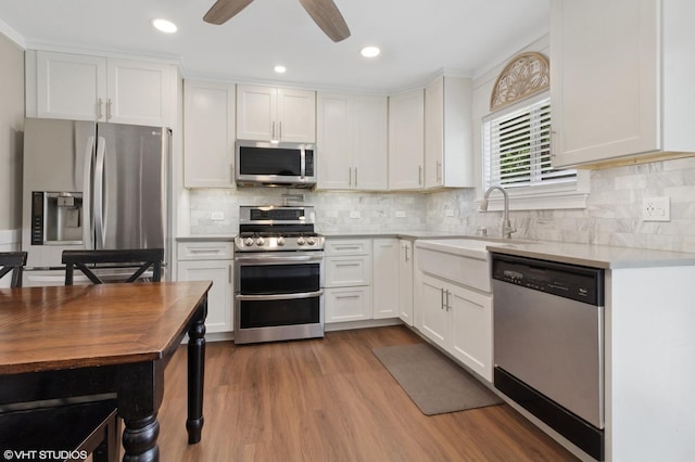 521 Everette Ave, Romeoville, IL 60446 - kitchen with appliances with stainless steel finishes, light countertops, white cabinets, dark wood finished floors, and recessed lighting
