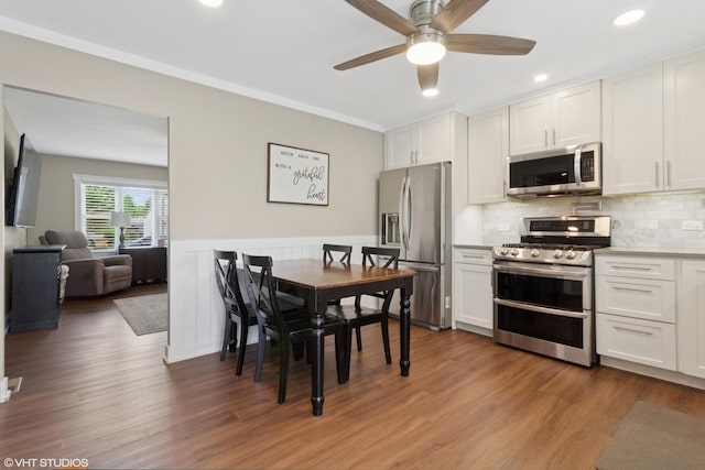 521 Everette Ave, Romeoville, IL 60446 - kitchen with appliances with stainless steel finishes, white cabinets, a ceiling fan, wood finished floors, and recessed lighting