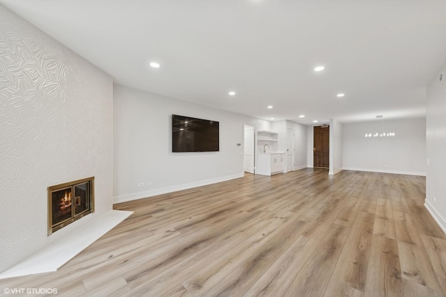 1140 Old Mill Rd Unit 505F, Hinsdale, IL 60521 - unfurnished living room with recessed lighting, light wood-style floors, and a large fireplace