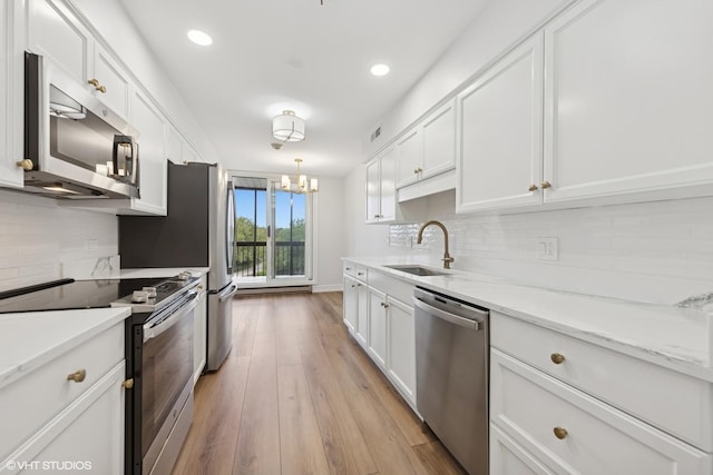 1140 Old Mill Rd Unit 505F, Hinsdale, IL 60521 - kitchen with appliances with stainless steel finishes, white cabinetry, backsplash, light wood-style flooring, and recessed lighting